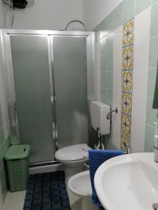 a bathroom with a shower and a toilet and a sink at Casa Maris in Santo Stefano di Camastra