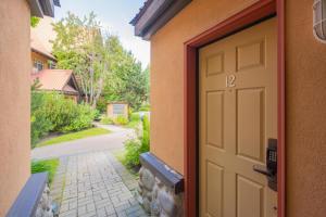 an open door to a house with a driveway at Sunpath by Outpost Whistler in Whistler