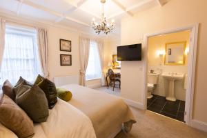 a bedroom with a bed and a bathroom at Warkworth House Hotel in Warkworth