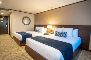 Postel nebo postele na pokoji v ubytování Grand Hotel Tijuana