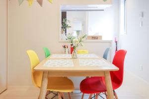 a dining room with a table and colorful chairs at Room 301 - Vacation STAY 86506 in Fukuoka