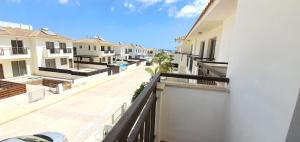 an apartment balcony with a view of a street at Villa Naxos in Protaras