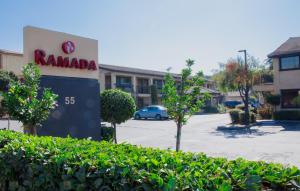 a sign for a rambala dealership in a parking lot at Ramada by Wyndham Mountain View in Mountain View