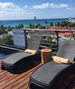 a balcony with a laptop computer on top of it at Sole Suites in Playa del Carmen