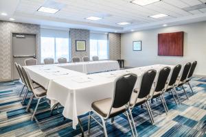 a conference room with a large white table and chairs at Holiday Inn Express Hotel & Suites Tappahannock by IHG in Tappahannock +19 photos