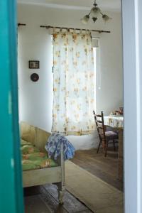 a bedroom with a bed and a window with a table at Vadrózsa Vendégház Rácalmás in Rácalmás