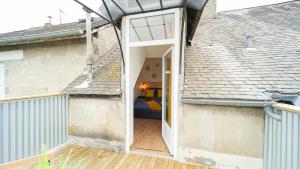 an open door to a bedroom in a house at Cosy Apparts Brive in Brive-la-Gaillarde