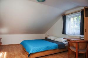 En eller flere senge i et værelse på Dom Gościnny "Satori"