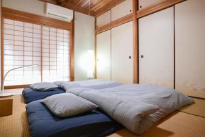 two beds in a room with windows at Kumage-gun - House - Vacation STAY 84975 in Yudomari