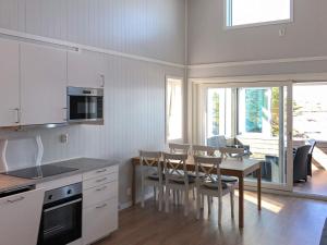 a kitchen and dining room with a table and chairs at 6 person holiday home in Dyrvik in Dyrvik