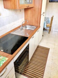 a kitchen with a sink and a dishwasher at Appartamento Maria Giovanna in Giardini Naxos