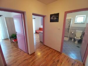 a room with a bathroom with a toilet and a sink at Apartments Sokolic in Nerezine +50 photos