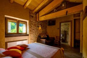 ein Schlafzimmer mit einem Bett, einem Fenster und einem Sofa in der Unterkunft b&b le nosare in Bosco Chiesanuova