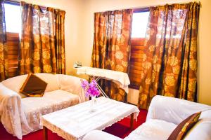 a living room with a couch and a table at Grand Eastern Hotel in Labasa