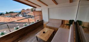 a balcony with a bench and a table at Villa Passage in Ohrid