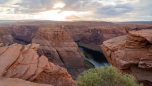 a view of a canyon with a river in it at Under Canvas Lake Powell-Grand Staircase in Big Water