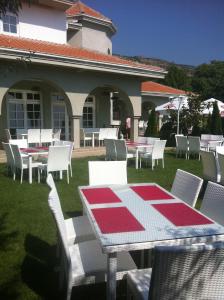 a table and chairs with a red and white table and chairs at Sunny House in Skopje +91 photos