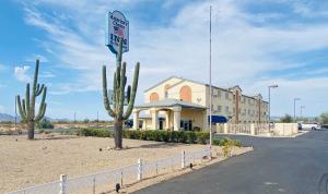 a building with a sign in the middle of a street at Americas Choice Inn & Suites in Gila Bend