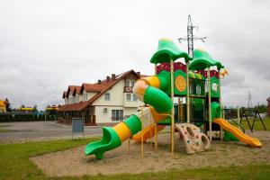 a playground with a slide in a park at Noclegi Cristal in Malbork