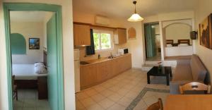 a large kitchen with a sink and a table at Villa Pappas in Kanali