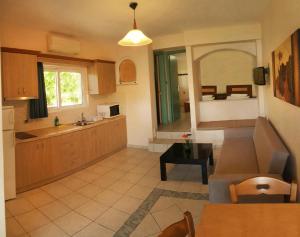 a large kitchen with a sink and a table at Villa Pappas in Kanali