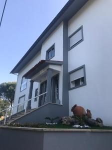 a white house with a window on the side of it at PinoyHouse Fatima in Fátima