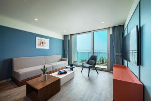 a living room with a couch and a chair at The Week & Resort in Incheon