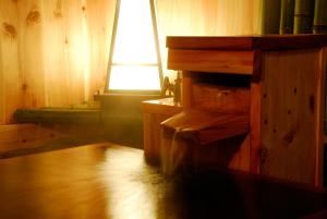 a room with a wooden floor and a window at Hakone Kowakien Mikawaya Ryokan in Hakone