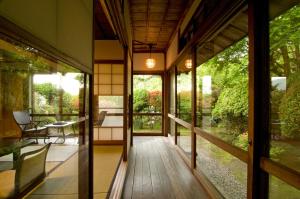 a hallway of a house with a table and chairs at Hakone Kowakien Mikawaya Ryokan in Hakone
