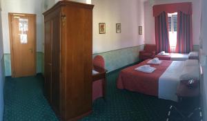 Postel nebo postele na pokoji v ubytování Hotel Astoria