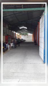 an empty building with people sitting on chairs in it at HOTEL CASA BLANCA BUGA in Buga