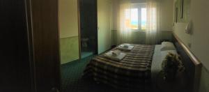 Postel nebo postele na pokoji v ubytování Hotel Astoria