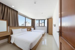 Llit o llits en una habitació de XO Hotel & Apartments