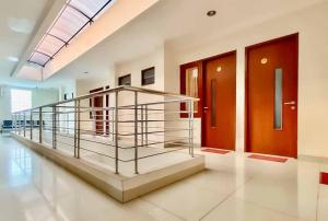 a lobby with a staircase and two doors at RedDoorz Syariah Plus near Cirebon Super Block Mall 2 in Cirebon
