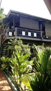 a building with plants in front of it at T Star Cottage Langkawi in Pantai Cenang