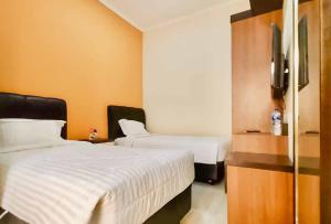 Postelja oz. postelje v sobi nastanitve RedDoorz Syariah Plus near Cirebon Super Block Mall 2