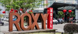 a large sign that says pray in front of a building at Roxy Hotel & Apartments in Kuching