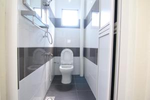 łazienka z toaletą, umywalką i oknem w obiekcie Homestay Hj Esmon 3 UTHM Parit Raja w mieście Parit Raja