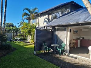 a shed with a table and chairs in a yard at The Park Hotel Motel, Suffolk Park in Byron Bay