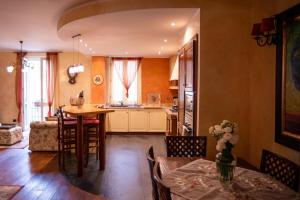a kitchen and living room with a table and chairs at La Casolicchia di Arona in Arona