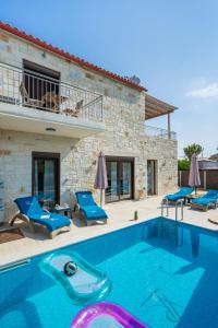 a swimming pool in front of a house at Villa Rebecca in Agia Marina Nea Kydonias