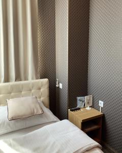 a bedroom with a bed and a table with a telephone at Hotel Banja Luka in Banja Luka +45 photos