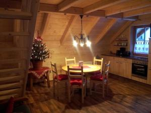 a dining room with a table and a christmas tree at Zimmer im Lungau in Sankt Michael im Lungau