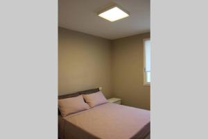 a small bedroom with a bed and a window at da Nonna Lidia in Fano