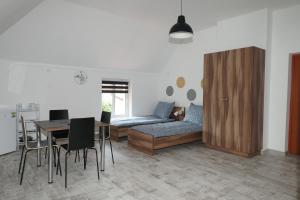 a living room with a couch and a table and chairs at Villa Kaszubska in Ustka