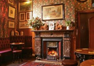 a fireplace in a pub with a fire place at Victoria inn in Durham