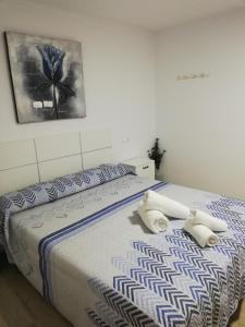 a bedroom with a bed with two towels on it at casa CAZORLA C DEL VALLE in Cazorla