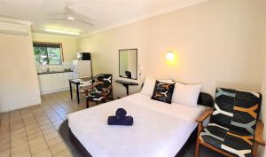 ein Schlafzimmer mit einem Bett mit einem lila Herz darauf in der Unterkunft Paradise Court Holiday Units in Airlie Beach