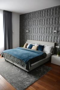 a bedroom with a large bed with blue comforter at Premium apartment near Banská Bystrica square with two big bedrooms in Banská Bystrica