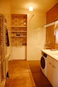 a bathroom with a washing machine and a sink at Premium apartment near Banská Bystrica square with two big bedrooms in Banská Bystrica
